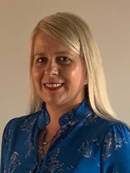 Silvia poses and smiles for the camera.